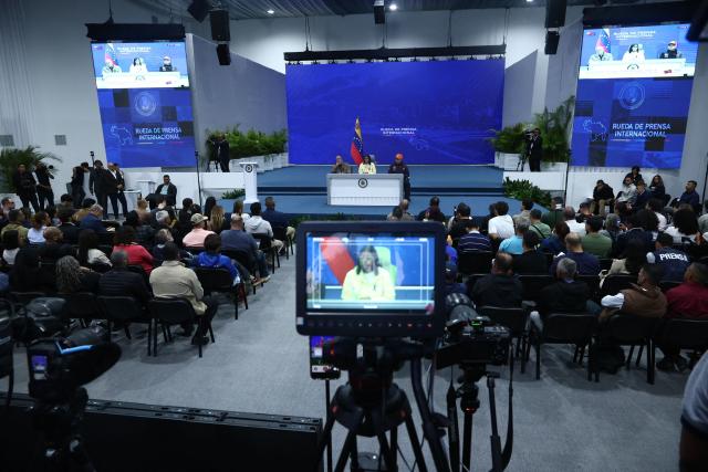 Venezuela's interim President Delcy Rodriguez (C) speaks during a press conference alongside National Assembly President Jorge Rodriguez (L) and Interior Minister Diosdado Cabello at the Generalisimo Francisco de Miranda Air Base in Caracas on July 2, 2026. At least 2,595 people have died as a result of the twin earthquakes that struck Venezuela on June 24, interim President Delcy Rodriguez announced on July 2, adding that all of the victims will be properly identified. (Photo by Lucas AGUAYO / AFP)