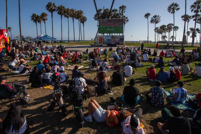 Fans watch the 2026 FIFA World Cup Round of 32 football match between Portugal and Croatia on a giant screen set on Venice Beach boardwalk in Venice, California, on July 2, 2026. (Photo by Apu GOMES / AFP)