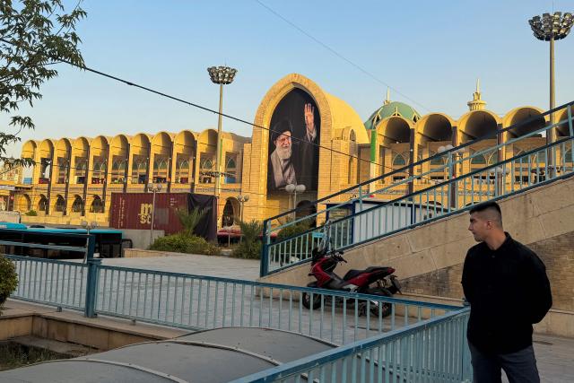 A man stands near the Grand Mosalla in Tehran on July 3, 2026, ahead of Iran's slain supreme leader Ali Khamenei's funeral. Preparations for the funeral of Khamenei were in full swing on July 3, with authorities expecting millions and a coterie of foreign dignitaries to attend the official ceremony. (Photo by Atta KENARE / AFP) / 