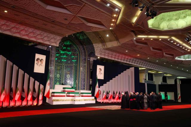 TOPSHOT - Local and foreign officials pay their respects in front of the coffins of Iran's slain supreme leader Ali Khamenei and his family members at the Grand Mosalla in Tehran on July 3, 2026. The body of Iran's supreme leader Ali Khamenei, who was killed in US-Israeli strikes, arrived at Tehran's Grand Mosalla religious complex ahead of his funeral, state media reported on July 3. (Photo by Atta KENARE / AFP) / 