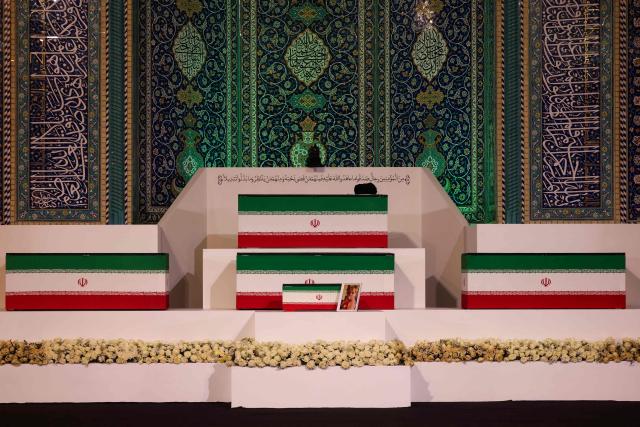 The coffins of Iran's slain supreme leader Ali Khamenei and his family members are pictured at the Grand Mosalla in Tehran on July 3, 2026. The body of Iran's supreme leader Ali Khamenei, who was killed in US-Israeli strikes, arrived at Tehran's Grand Mosalla religious complex ahead of his funeral, state media reported on July 3. (Photo by Atta KENARE / AFP) / 