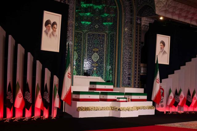 The coffins of Iran's slain supreme leader Ali Khamenei and his family members are pictured at the Grand Mosalla in Tehran on July 3, 2026. The body of Iran's supreme leader Ali Khamenei, who was killed in US-Israeli strikes, arrived at Tehran's Grand Mosalla religious complex ahead of his funeral, state media reported on July 3. (Photo by Atta KENARE / AFP) / 
