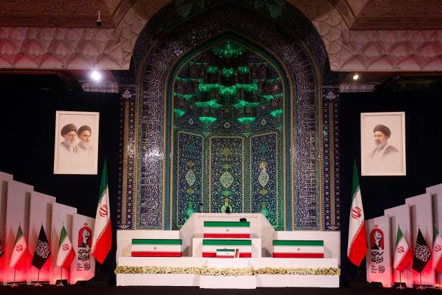 The coffins of Iran's slain supreme leader Ali Khamenei and his family members are pictured at the Grand Mosalla in Tehran on July 3, 2026. The body of Iran's supreme leader Ali Khamenei, who was killed in US-Israeli strikes, arrived at Tehran's Grand Mosalla religious complex ahead of his funeral, state media reported on July 3. The body of Iran's supreme leader who was killed in US-Israeli strikes that triggered the Middle East war arrived at Tehran's Grand Mosalla on Friday ahead of his funeral, state media reported. Millions of people and a coterie of foreign dignitaries were expected to attend July 4 official ceremony for Ali Khamenei, with Tehran's chief negotiator calling for a massive turnout to avenge his death. (Photo by Atta KENARE / AFP) / 