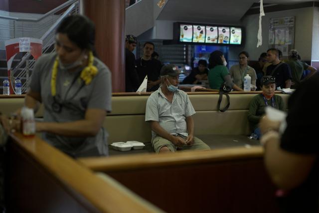 People receive medical attention in a McDonald's restaurant that was turned into a shelter and makeshift hospital to assist earthquake victims, in Caraballeda, La Guaira, on July 1, 2026. More than a week after the earthquakes struck, there is little chance of finding additional survivors from the two earthquakes that killed nearly 2,500 people, destroyed entire residential buildings, and left tens of thousands missing. (Photo by Rosali Hernandez / AFP)