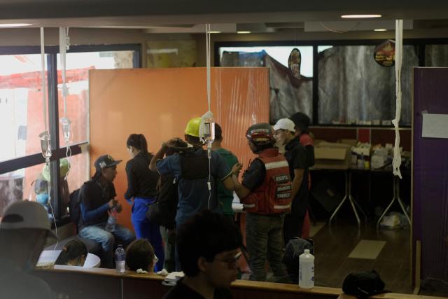 People receive medical attention in a McDonald's restaurant that was turned into a shelter and makeshift hospital to assist earthquake victims, in Caraballeda, La Guaira, on July 1, 2026. More than a week after the earthquakes struck, there is little chance of finding additional survivors from the two earthquakes that killed nearly 2,500 people, destroyed entire residential buildings, and left tens of thousands missing. (Photo by Rosali Hernandez / AFP)