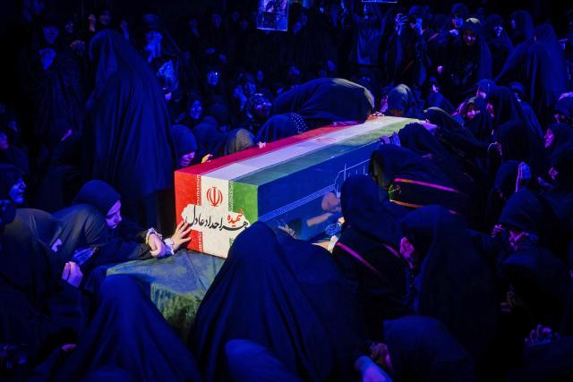 TOPSHOT - Mourners offer prayers beside the coffin of Zahra Haddad Adel, wife of Iran's supreme leader Mojtaba Khamenei, during her funeral in Tehran on July 2, 2026. Mojtaba Khamenei's wife, Zahra Haddad Adel, the daughter of former parliament speaker Gholam Ali Haddad Adel, died on February 28 in the US-Israeli strikes that killed ex-supreme leader Khamenei, according to the Iranian authorities. (Photo by - / FARS NEWS AGENCY / AFP / FARS NEWS AGENCY / AFP)