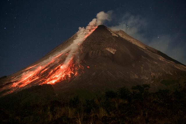 TOPSHOT - Lava and pyroclastic flows erupt from the summit of Mount Merapi during an eruption, as seen from Ngori Hamlet, Central Java, on July 3, 2026. (Photo by DEVI RAHMAN / AFP)