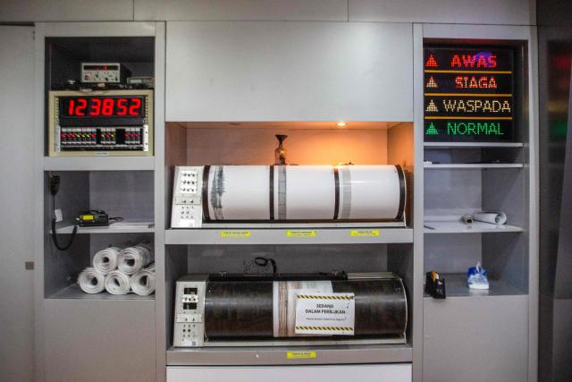 A drum seismograph prints real-time seismic data from monitoring stations around Mount Merapi at the office of the Geological Disaster Technology Research and Development Center (BPPTKG) in Yogyakarta on July 2, 2026. BPPTKG is the Indonesian government agency responsible for 24-hour monitoring, research and hazard mitigation of Mount Merapi. (Photo by DEVI RAHMAN / AFP)