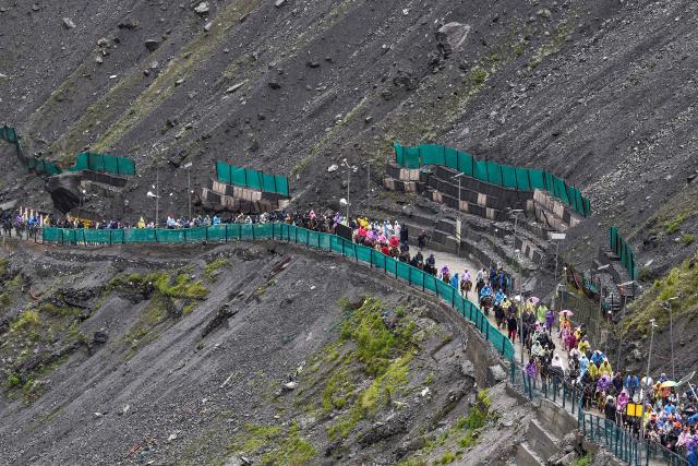Hindu devotees make their way along a mountain path during their annual pilgrimage to the cave shrine of Amarnath, near Baltal in Kashmir on July 3, 2026. (Photo by AFP)
