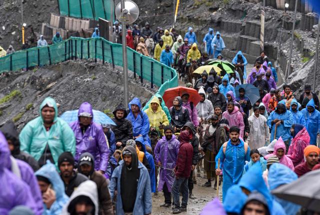 Hindu devotees make their way along a mountain path during their annual pilgrimage to the cave shrine of Amarnath, near Baltal in Kashmir on July 3, 2026. (Photo by AFP)