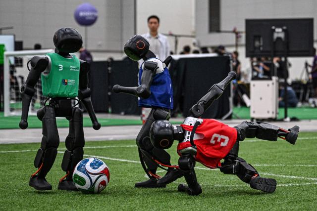Robots take part in a football match at RoboCup 2026, a robotics and Artificial Intelligence (AI) competition in Incheon on July 3, 2026. (Photo by Jade GAO / AFP)