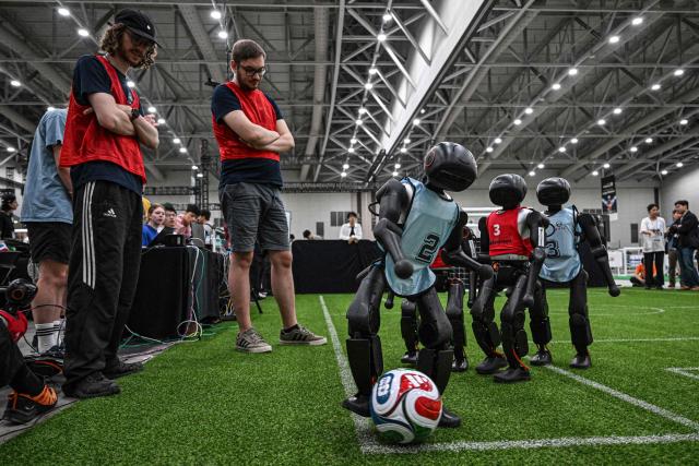 Robots take part in a football match at RoboCup 2026, a robotics and Artificial Intelligence (AI) competition in Incheon on July 3, 2026. (Photo by Jade GAO / AFP)