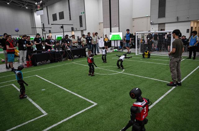 Robots take part in a football match at RoboCup 2026, a robotics and Artificial Intelligence (AI) competition in Incheon on July 3, 2026. (Photo by Jade GAO / AFP)