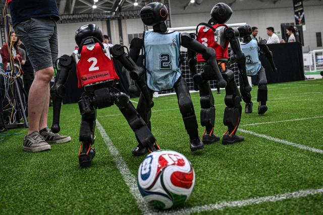 Robots take part in a football match at RoboCup 2026, a robotics and Artificial Intelligence (AI) competition in Incheon on July 3, 2026. (Photo by Jade GAO / AFP)