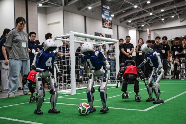Robots take part in a football match at RoboCup 2026, a robotics and Artificial Intelligence (AI) competition in Incheon on July 3, 2026. (Photo by Jade GAO / AFP)