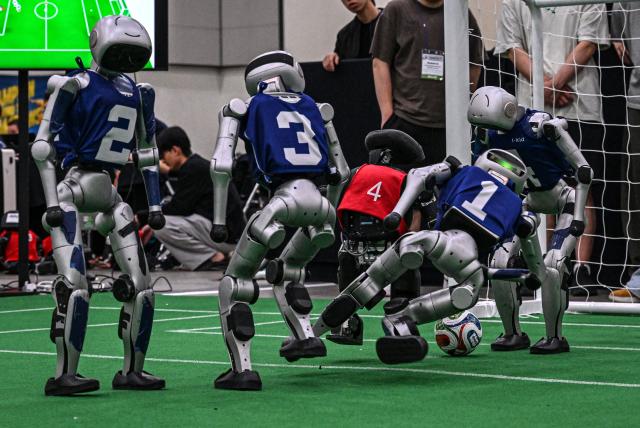 Robots take part in a football match at RoboCup 2026, a robotics and Artificial Intelligence (AI) competition in Incheon on July 3, 2026. (Photo by Jade GAO / AFP)