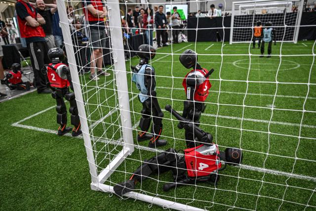 Robots take part in a football match at RoboCup 2026, a robotics and Artificial Intelligence (AI) competition in Incheon on July 3, 2026. (Photo by Jade GAO / AFP)