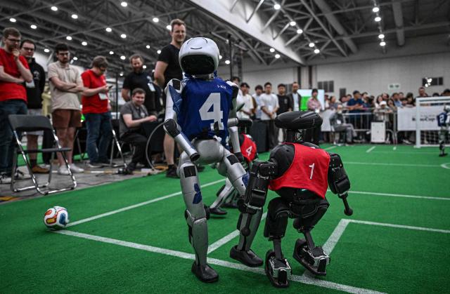 Robots take part in a football match at RoboCup 2026, a robotics and Artificial Intelligence (AI) competition in Incheon on July 3, 2026. (Photo by Jade GAO / AFP)