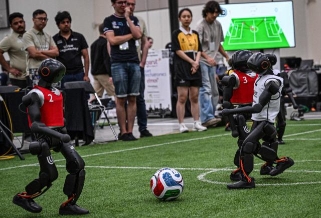 Robots take part in a football match at RoboCup 2026, a robotics and Artificial Intelligence (AI) competition in Incheon on July 3, 2026. (Photo by Jade GAO / AFP)