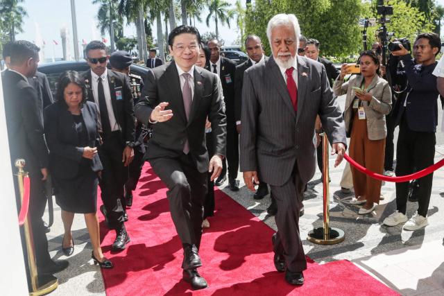 Singaporean Prime Minister Lawrence Wong (L) and East Timor's Prime Minister Xanana Gusmao (R) walk at the Government Palace in Dili on July 3, 2026. (Photo by Valentino Dariell DE SOUSA / AFP)