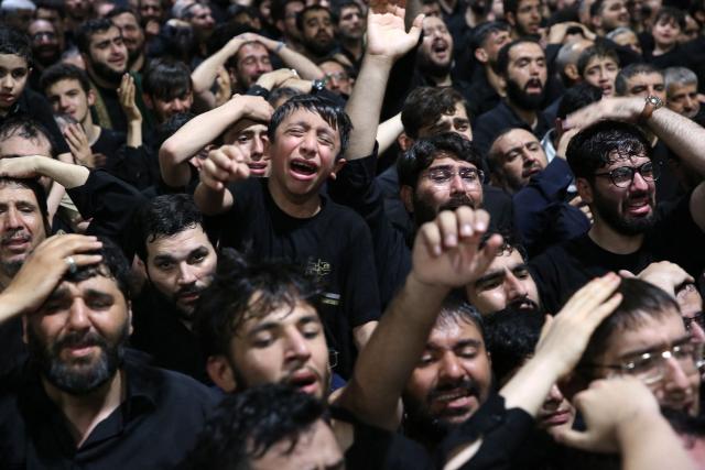 This handout photograph provided by the Iranian supreme leader office (Khamenei.IR) shows mourners gathering around the coffin of Iran's slain supreme leader Ali Khamenei during a ceremony ahead of his funeral in Tehran on July 3, 2026. The body of Iran's supreme leader Ali Khamenei, who was killed in US-Israeli strikes, arrived at Tehran's Grand Mosalla religious complex ahead of his funeral, state media reported on July 3. (Photo by KHAMENEI.IR / AFP) / 