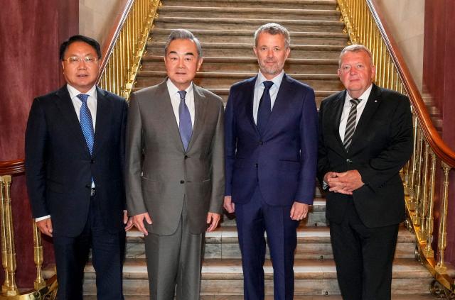 (L-R) China's ambassador to Denmark Wang Xuefeng, China's Foreign Minister Wang Yi, King Frederik X of Denmark and Danish Foreign Minister Lars Loekke Rasmussen pose at Amalienborg Palace in Copenhagen, on July 3, 2026. The Chinese Foreign Minister is on a two day visit to Denmark and will then visit Sweden, Finland, and Norway. (Photo by Liselotte Sabroe / Ritzau Scanpix / AFP) / Denmark OUT