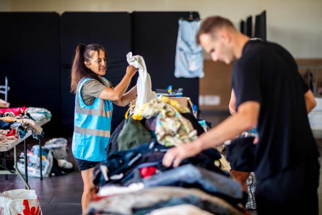 Local volunteers collect clothes for tourists and evacuees at a reception center in Canet-en-Roussillon, the day after a wildfire broke out in the south of France, on July 3, 2026. Nearly 3,000 people had to be evacuated from several campsites, as well as from businesses and several municipalities, after a fire broke out in Sainte-Marie-la-Mer and spread on to Canet-en-Roussillon, affecting the watersports hub, firefighters and the prefect of Pyrenees-Orientales said on July 2, 2026. (Photo by Jc Milhet / AFP)