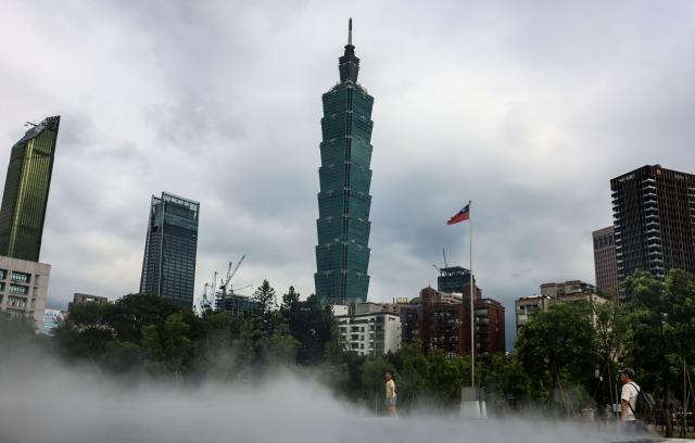 A mist installation is seen at Sun Yat-sen Memorial Hall with Taipei 101 in the background, in Taipei on July 3, 2026 (Photo by I-Hwa Cheng / AFP)