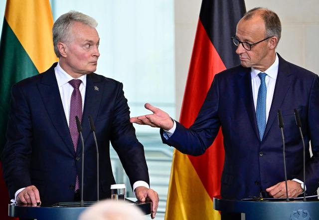 Lithuania's President Gitanas Nauseda (L) and German Chancellor Friedrich Merz attend a joint press conference after a meeting at the Chancellery in Berlin on July 3, 2026. (Photo by Tobias SCHWARZ / AFP)