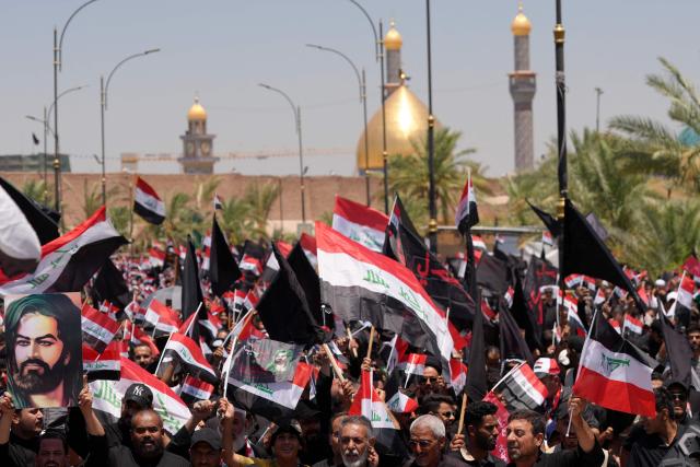 Supporters of Shia cleric Muqtada al-Sadr, wave flags as they take part in a demonstration supporting Iraqi Prime Minister Ali al-Zaidi’s government-led anti-corruption campaign, in Najaf on July 3, 2026. Iraq's new prime minister, Ali al-Zaidi, who recently took office with the blessing of the United States, has made two main vows: to fight corruption and to ensure a state monopoly on weapons. (Photo by Qassem al-KAABI / AFP)