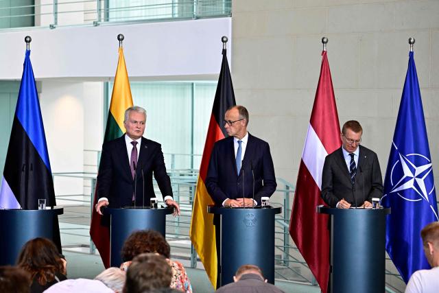 (LtoR) Lithuanian President Gitanas Nauseda, German Chancellor Friedrich Merz and Latvian President Edgars Rinkevics address a joint press conference following a meeting at the Chancellery in Berlin on July 3, 2026. Lithuania's president said on July 3 his country wants to be integrated into Western nuclear deterrence against Russia, at a time of heightened tension between Russia and its Baltic neighbours. (Photo by Tobias SCHWARZ / AFP)