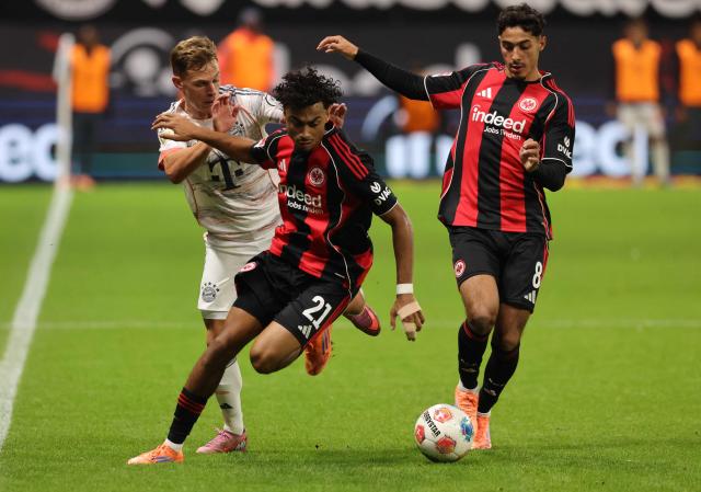 (FILES) Bayern Munich's German midfielder #06 Joshua Kimmich vies for the ball with Frankfurt's German defender #21 Nathaniel Brown and Frankfurt's Algerian midfielder #08 Fares Chaibi during the German first division Bundesliga football match between Eintracht Frankfurt and FC Bayern Munich in Frankfurt am Main, western Germany, on October 4, 2025. FC Bayern have signed Germany international Nathaniel Brown, 23, from Eintracht Frankfurt on a contract until June 30, 2031 the club announced on July 3, 2026. (Photo by Daniel ROLAND / AFP)