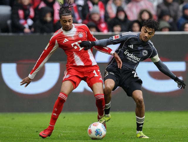 (FILES) Bayern Munich's French midfielder #17 Michael Olise (L) and Frankfurt's German defender #21 Nathaniel Brown vie for the ball during the German first division Bundesliga football match between FC Bayern Munich and Eintracht Frankfurt in Munich, southern Germany, on February 21, 2026. FC Bayern have signed Germany international Nathaniel Brown, 23, from Eintracht Frankfurt on a contract until June 30, 2031 the club announced on July 3, 2026. (Photo by Alexandra BEIER / AFP) / DFL REGULATIONS PROHIBIT ANY USE OF PHOTOGRAPHS AS IMAGE SEQUENCES AND/OR QUASI-VIDEO