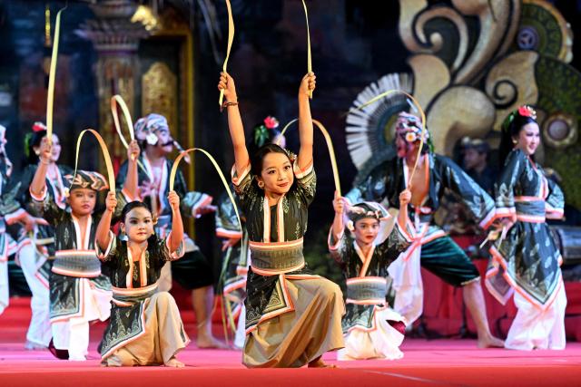 Balinese dancers perform during the Bali Art Festival in Denpasar, Indonesia's resort island of Bali on July 3, 2026. (Photo by SONNY TUMBELAKA / AFP)