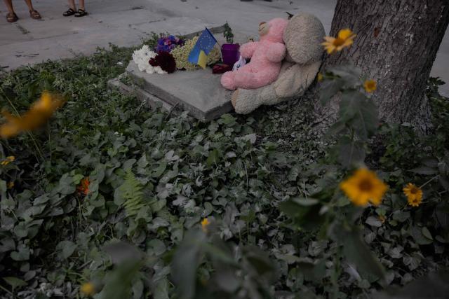 This photograph shows flowers and soft toys displayed at a makeshift memorial near a residential building damaged following a Russian air attack on the Ukrainian capital of Kyiv on July 3, 2026, amid the Russian invasion in Ukraine. Russia launched its largest ever barrage on Kyiv early July 2, 2026, according to the city's mayor, tearing open apartment buildings in an hours-long drone and missile attack that killed at least 30 people. (Photo by Tetiana DZHAFAROVA / AFP)