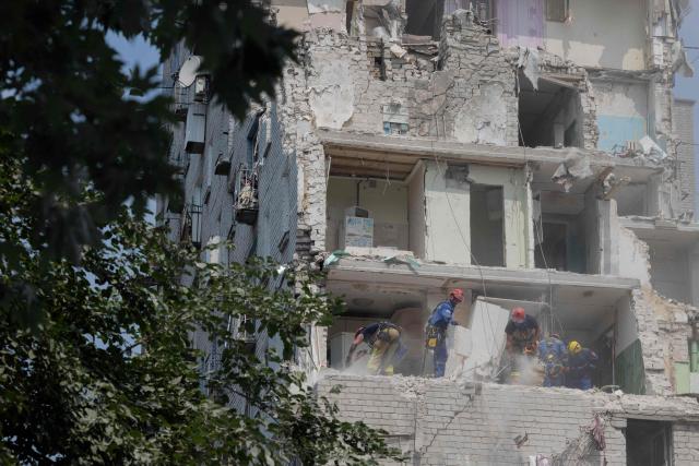 Rescue workers are working in a residential building damaged following a Russian air attack on the Ukrainian capital of Kyiv on July 3, 2026, amid the Russian invasion in Ukraine. Russia launched its largest ever barrage on Kyiv early July 2, 2026, according to the city's mayor, tearing open apartment buildings in an hours-long drone and missile attack that killed at least 30 people. (Photo by Tetiana DZHAFAROVA / AFP)