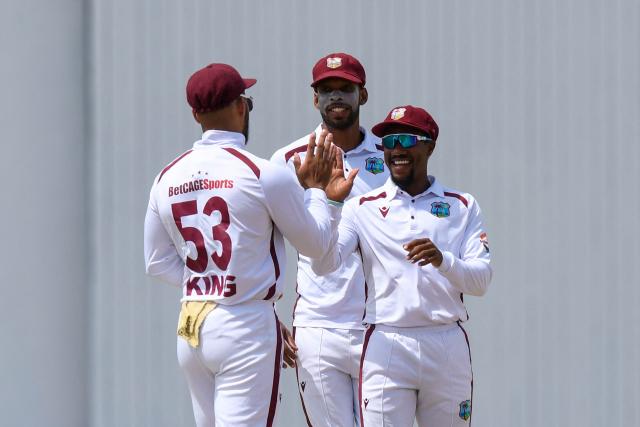 Brandon King (L), Roston Chase (C) and Kavem Hodge (R) of West Indies celebrate the dismissal of Nishan Madushka of Sri Lanka during the 1st day of the 2nd Test between Sri Lanka and West Indies at Vivian Richards Cricket Stadium in North Sound, Antigua and Barbuda, on July 03, 2026. (Photo by Randy Brooks / AFP)