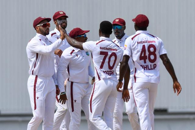 Brandon King (L) and Shamar Joseph (3R) of West Indies celebrate the dismissal of Nishan Madushka of Sri Lanka during the 1st day of the 2nd Test between Sri Lanka and West Indies at Vivian Richards Cricket Stadium in North Sound, Antigua and Barbuda, on July 3, 2026. (Photo by Randy Brooks / AFP)