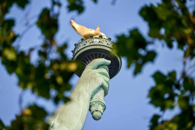 The Statue of Liberty's torch is seen ahead of celebrations for the 250th anniversary of US independence on Liberty Island in New York City, on July 1, 2026. Techno music and lasers brought the Statue of Liberty to life as a light show at the iconic monument will be broadcast on July 3, 2026, to mark the United States' 250th anniversary. The 15-minute spectacle will be shown on the ABC network as an initiative of France, which gifted the monument to the United States in 1886 in celebration of American independence. (Photo by ANGELA WEISS / AFP)