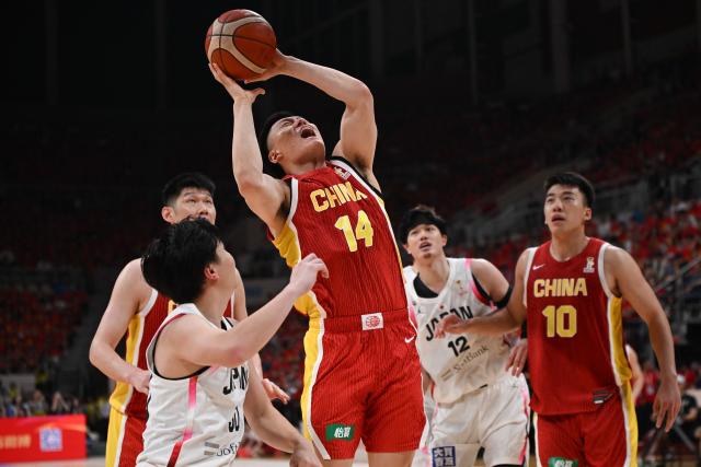 China’s Li Hongquan shoots as Japan’s Keisei Tominaga, Yuta Watanabe and China’s Wang Junjie look on during the FIBA Basketball World Cup 2027 Asian Qualifiers game between China and Japan in Shenyang, China’s Liaoning Province on July 3, 2026. (Photo by CN-STR / AFP) / China OUT