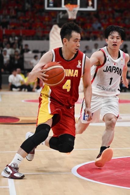 China’s Zhao Jiwei controls the ball next to Japan’s Takumi Saito during the FIBA Basketball World Cup 2027 Asian Qualifiers game between China and Japan in Shenyang, China’s Liaoning Province on July 3, 2026. (Photo by CN-STR / AFP) / China OUT