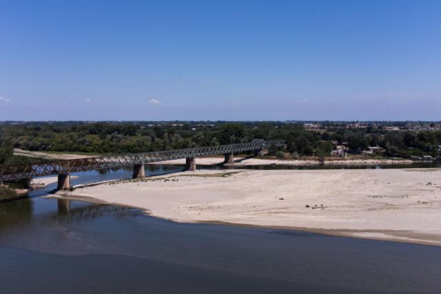 A general view shows sandbanks along river Po at Ponte della Becca, near Pavia, Northern Italy on July 3, 2026. Several waterways in northern Italy are in a "critical state" due to drought, and the weather forecast bodes ill for the coming days, the Po River Authority (ADBPO) said on July 3, 2026. (Photo by Piero CRUCIATTI / AFP)