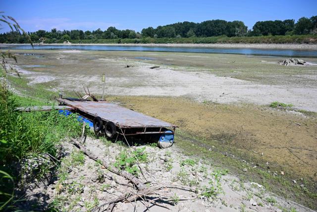 A floating dock for boats is seen lying on the riverbed along the river Po in Castelvetro Piacentino, near Cremona, Northern Italy on July 3, 2026. Several waterways in northern Italy are in a "critical state" due to drought, and the weather forecast bodes ill for the coming days, the Po River Authority (ADBPO) said on July 3, 2026. (Photo by Piero CRUCIATTI / AFP)