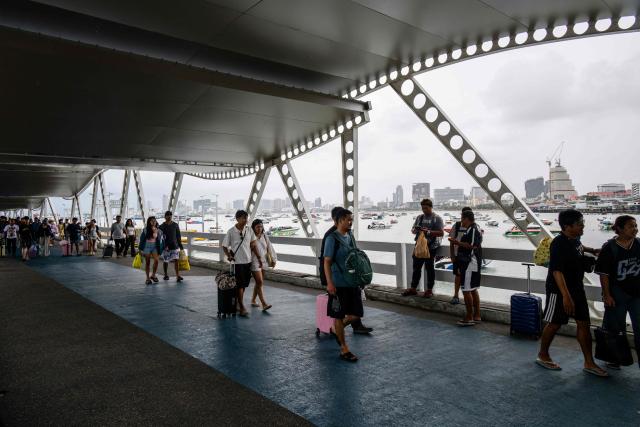 Tourists walk along Bali Hai Pier in Pattaya on July 3, 2026. (Photo by ANTHONY WALLACE / AFP)