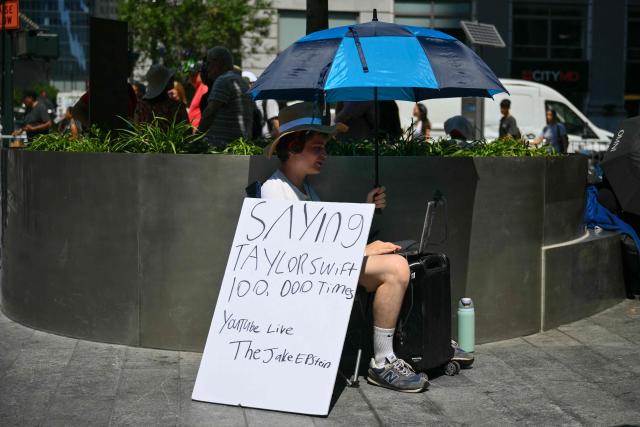 A fan of Taylor Swift sits in the shade outside Madison Square Garden, the reported venue for the wedding celebrations of pop singer Taylor Swift and pro-athlete Travis Kelce, in New York City on July 3, 2026. Swift and Kelce's official wedding plans are tightly under wraps, but New York is bracing to host the celebrity marriage of the year this week at Madison Square Garden. The wedding will reportedly take place Friday with a star-studded guest list of around 1,000, including models Gigi Hadid and Cara Delevingne, singer Selena Gomez, and actress Zoe Kravitz -- all known to be close Swift pals -- and Kelce's Kansas City Chiefs teammates. (Photo by ANGELA WEISS / AFP)