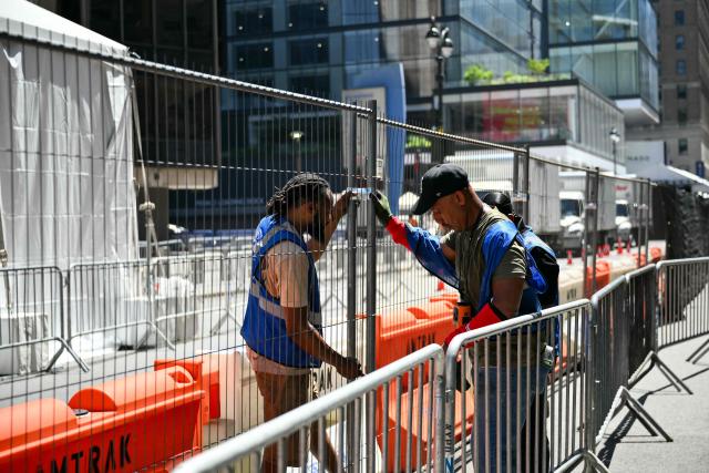Workers set up security fencing outside Madison Square Garden, the reported venue for the wedding celebrations of pop singer Taylor Swift and pro-athlete Travis Kelce, in New York City on July 3, 2026. Swift and Kelce's official wedding plans are tightly under wraps, but New York is bracing to host the celebrity marriage of the year this week at Madison Square Garden. The wedding will reportedly take place Friday with a star-studded guest list of around 1,000, including models Gigi Hadid and Cara Delevingne, singer Selena Gomez, and actress Zoe Kravitz -- all known to be close Swift pals -- and Kelce's Kansas City Chiefs teammates. (Photo by ANGELA WEISS / AFP)