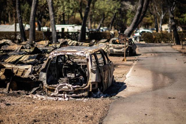 This photograph shows debris and burnt-out cars at the camping 'Le Brasilia', a day after a fire broke out, in Canet-en-Roussillon, southern France on July 3, 2026. Nearly 3,000 people had to be evacuated from several campsites, as well as from businesses and several municipalities, after a fire broke out in Sainte-Marie-la-Mer and spread on to Canet-en-Roussillon, affecting the watersports hub, firefighters and the prefect of Pyrenees-Orientales said on July 2, 2026. (Photo by Jean-Christophe MILHET / AFP)