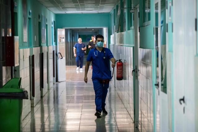 Health workers walk through the interior of the Hermanos Ameijeiras Clinical Surgical Hospital in Havana, on July 2, 2026. (Photo by YAMIL LAGE / AFP)