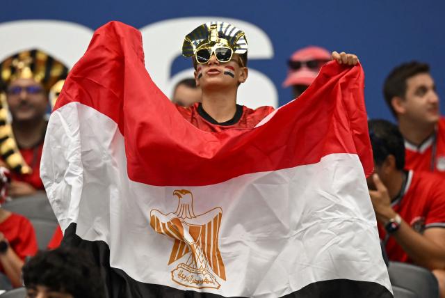 An Egypt supporter poses with the national flag prior to the 2026 World Cup round of 32 football match between Australia and Egypt at the Dallas Stadium in Arlington on July 3, 2026.  (Photo by Paul ELLIS / AFP)