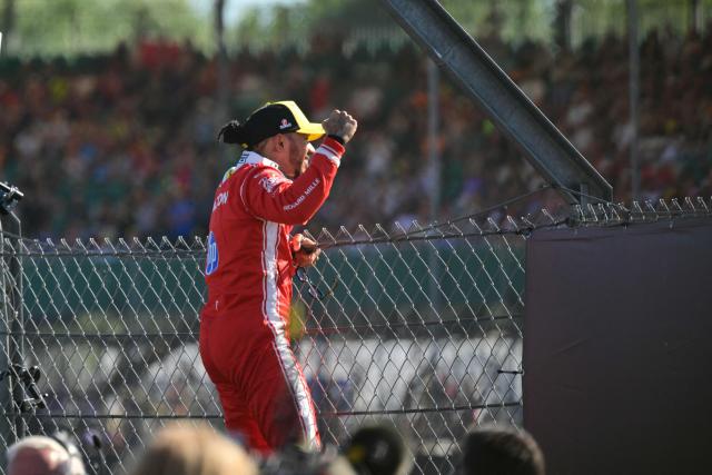 Ferrari's British driver Lewis Hamilton celebrates with fans after his pole position in the sprint qualifying session ahead of the Formula One British Grand Prix at the Silverstone motor racing circuit in Silverstone, central England, on July 3, 2026. (Photo by Andrej ISAKOVIC / AFP)